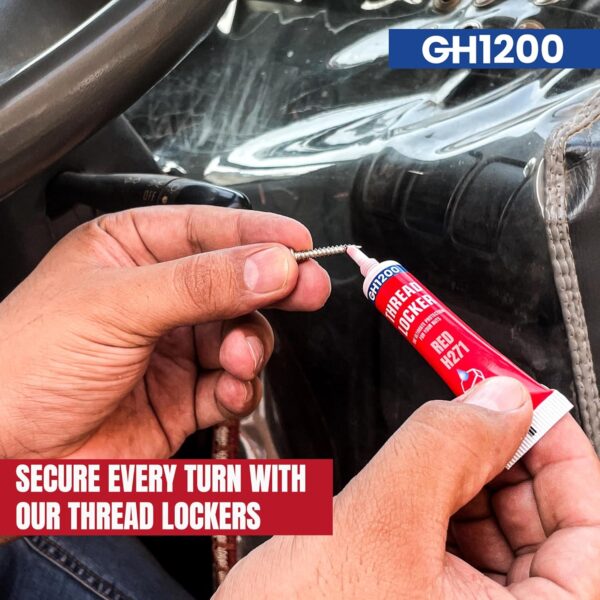Hand applying GH1200 red thread locker H271 to a metal screw in an automotive setup